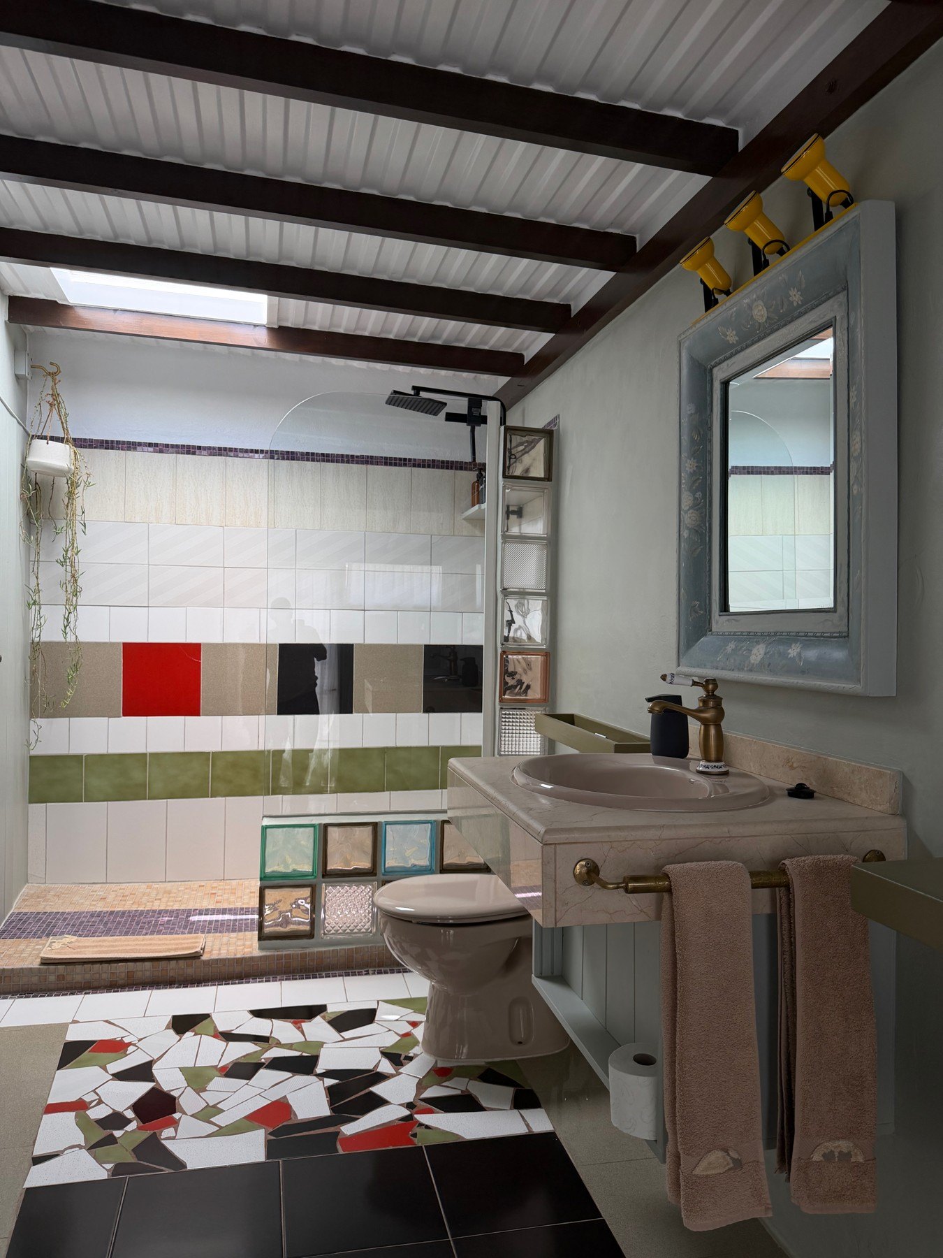 The bathroom — the largest at Mozagamod, with its mosaic floor and glass blocks